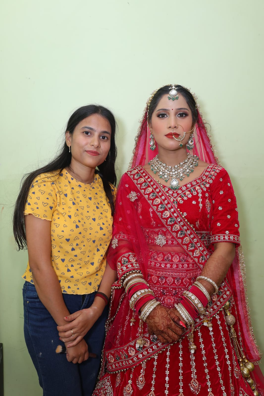 A luxurious bridal makeover highlighting glowing skin, beautifully blended eyeshadow, and a graceful finish that complements the bride’s traditional elegance.